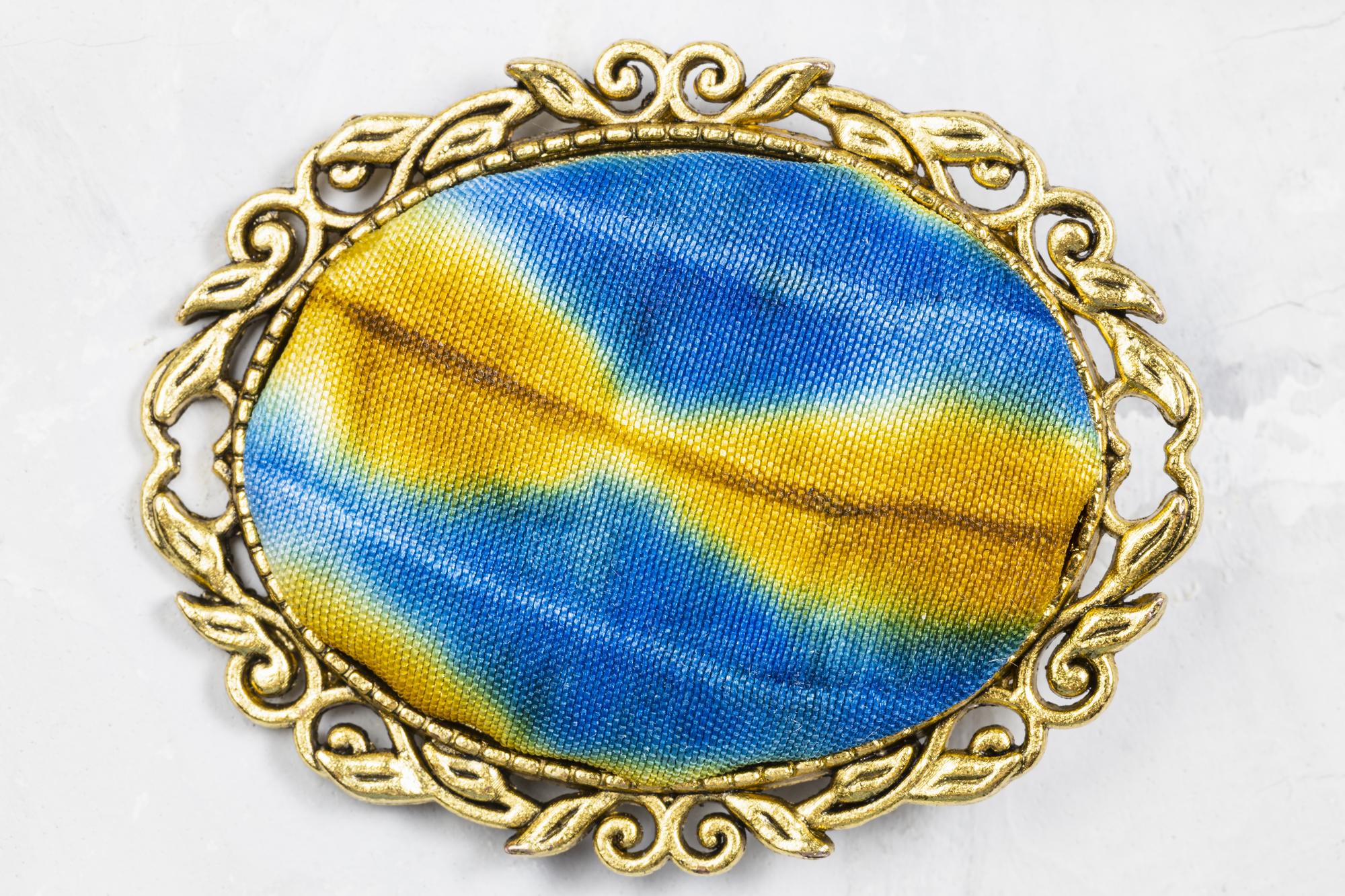 close detail of crest-style patch with metallic thread